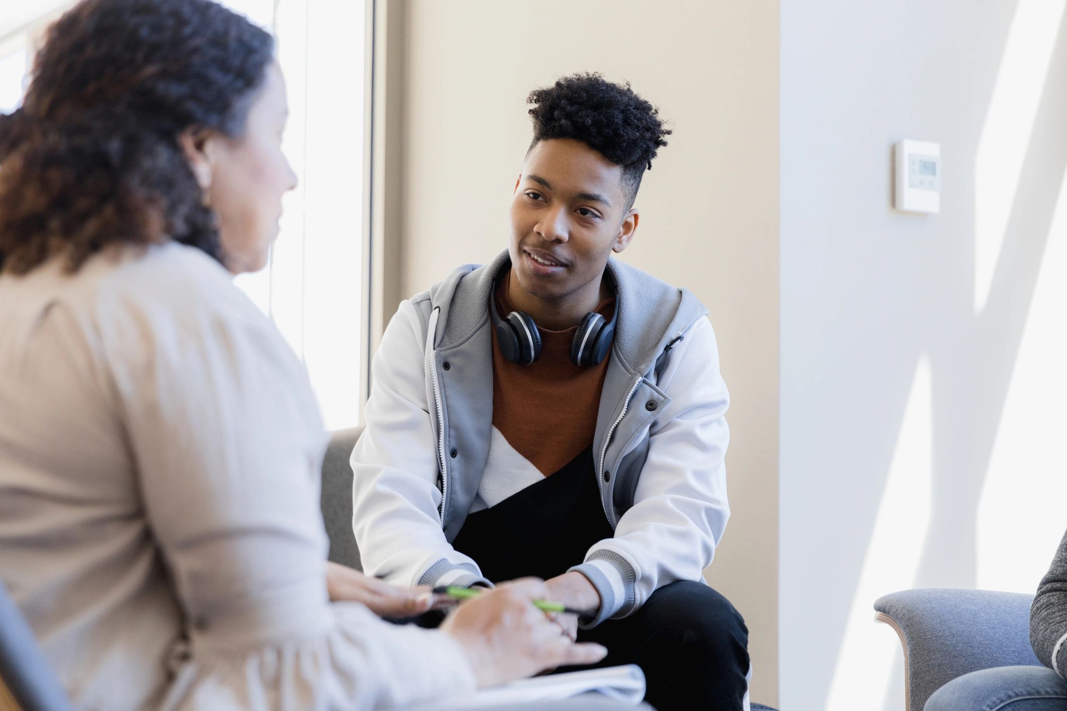 Mentor speaking with a young person in a supportive setting