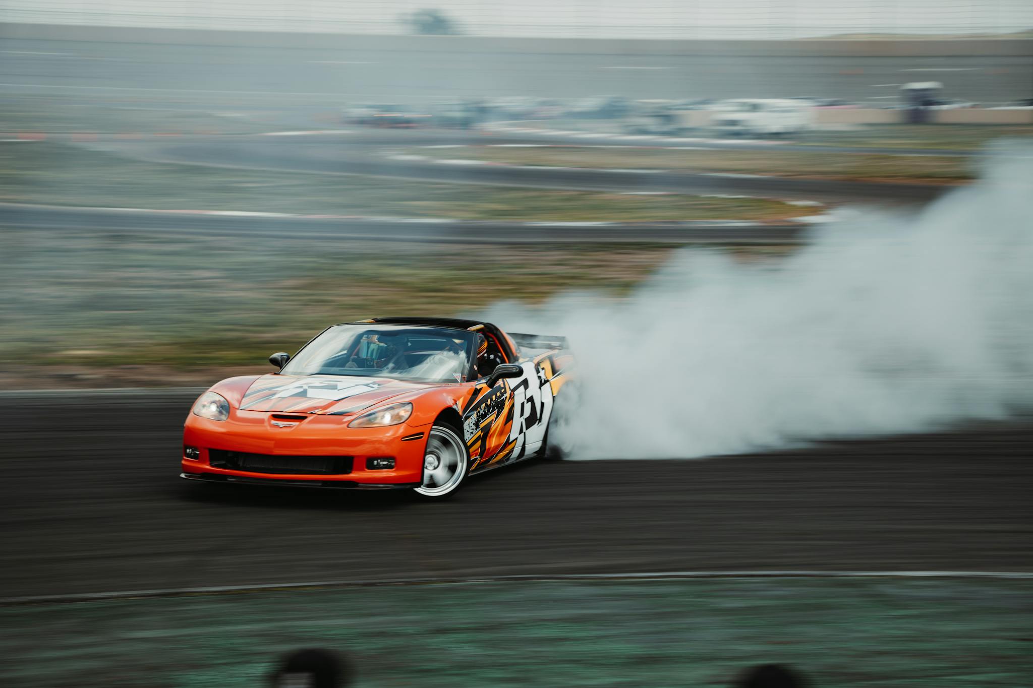 Exciting drift racing car emitting smoke during a race in Colorado.